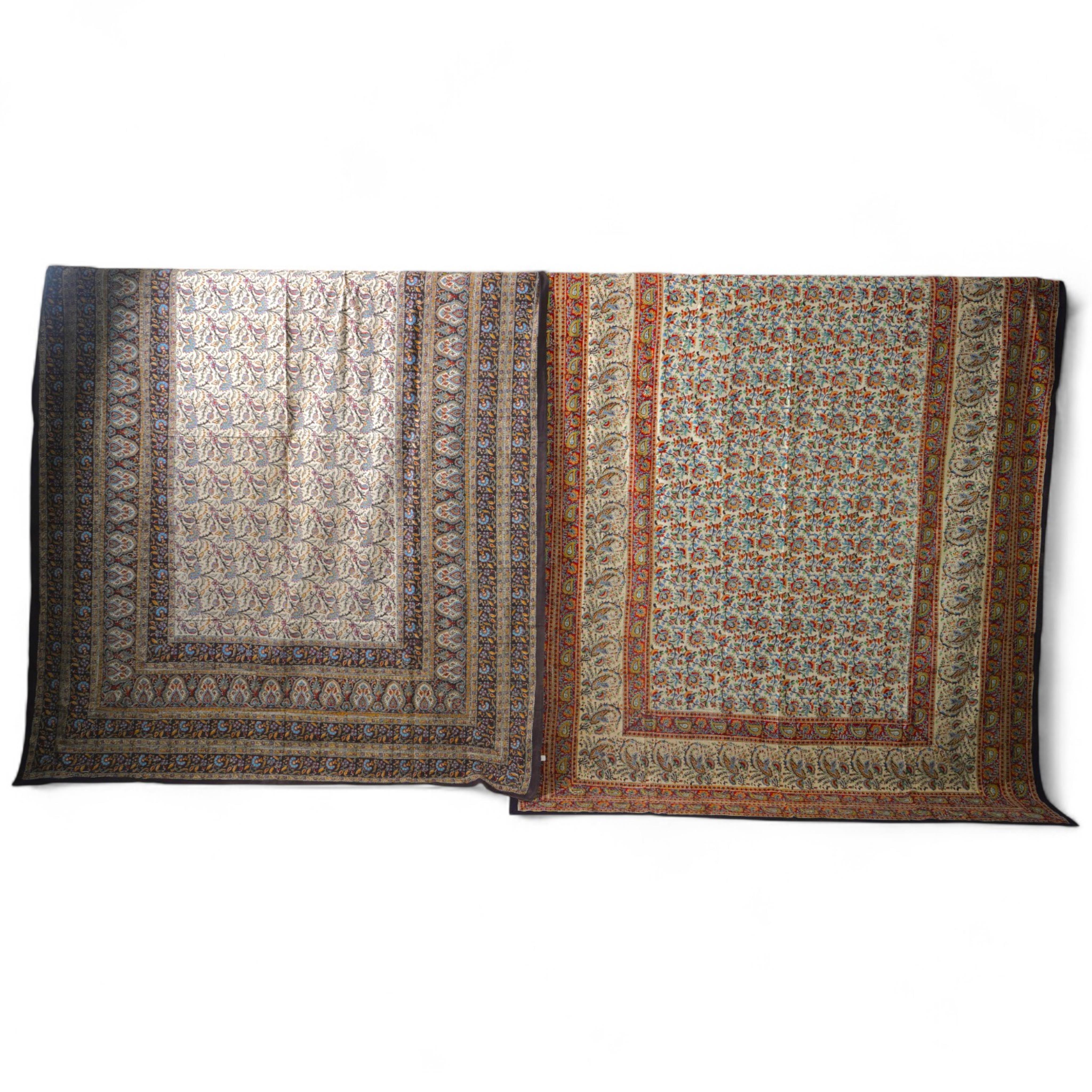 Two late 20th century large Indian block printed cotton bedcovers. One printed with brown borders, the other with brick red borders, both with large central panels designed in a classical Indian floral vining design. Bro